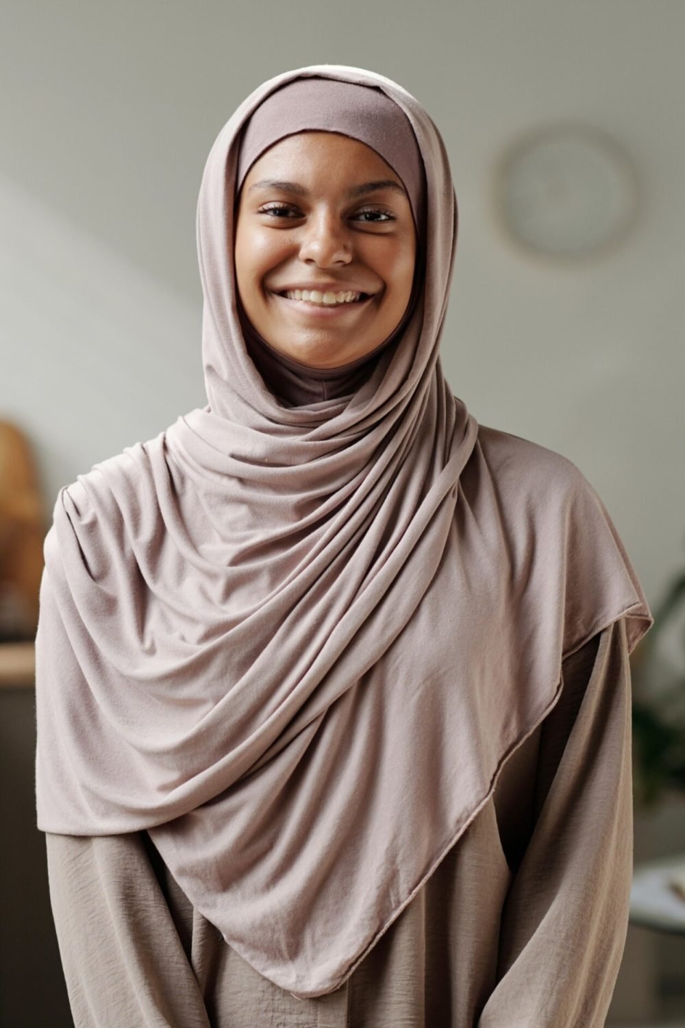 happy-young-muslim-woman-in-beige-hijab-standing-i-KTSQ929.jpg
